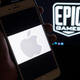 The Apple logo on an iPhone alongside the Epic Games logo on a laptop, April 2021.